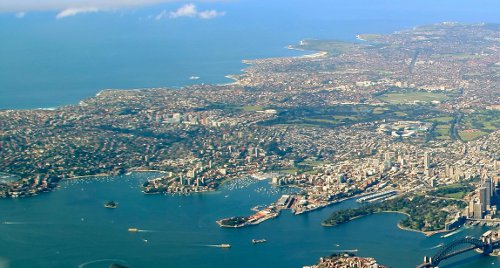 Eastern Sydney on the left. Harbour Bridge at bottom right, with Central Business District. Photo taken from Northern Sydney